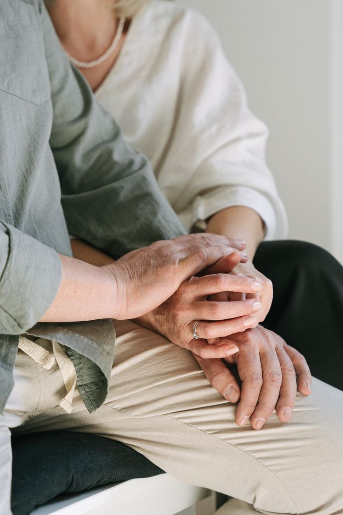 Close-up of a couple holding hands, symbolizing love and togetherness in a serene setting.